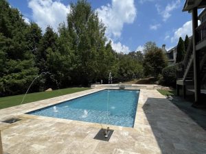 Backyard pool with fountains and patio