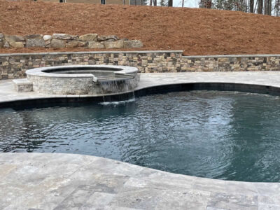 Outdoor pool with stone waterfall feature