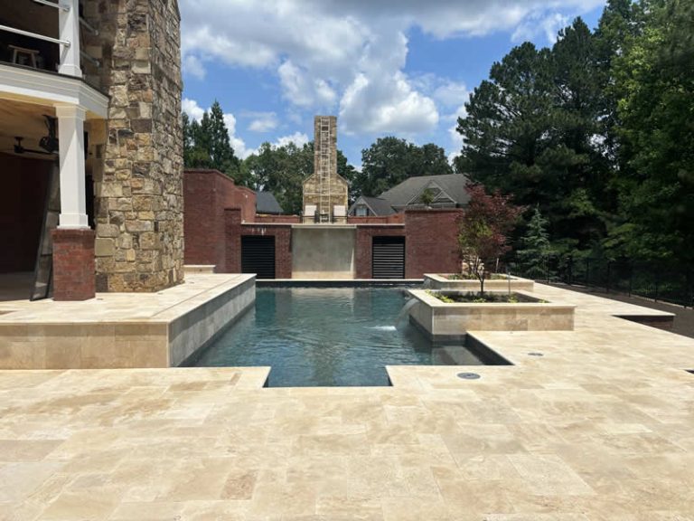 Elegant backyard pool with stone and brick design.