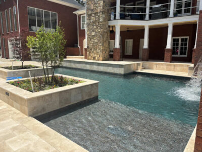 Modern patio with pool and stone fireplace