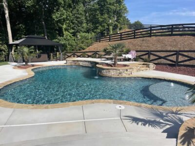 Backyard pool with stone patio and gazebo