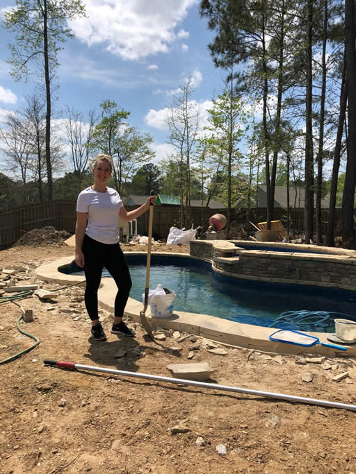 Person standing by pool under construction.