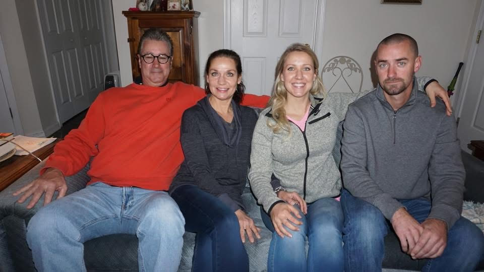 Smiling group sitting together on a couch