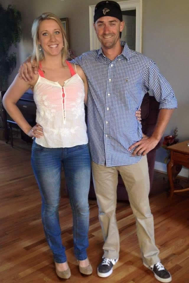 Smiling couple posing in casual attire indoors