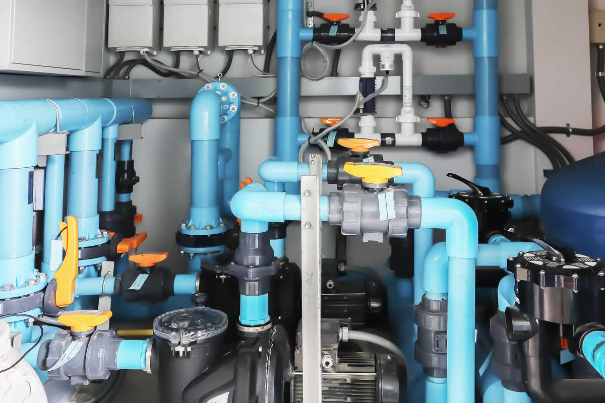 Complex plumbing system with blue pipes and valves.