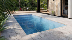 Modern tropical patio with rectangular blue swimming pool